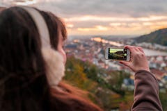 Young girl taking a photo of Heidelberg from the hill royalty free stock photography Young girl taking a photo of Heidelberg from the hill royalty free stock photography