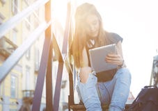Young girl watching tablet in milan stock photo Young girl watching tablet in milan stock photo