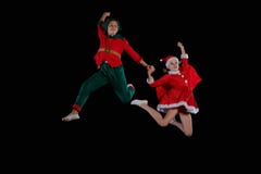 Christmas time, childhood, fairy tale. A young girl wearing a Santa`s costume and boy wearing elf costume flying royalty free stock photos Christmas time, childhood, fairy tale. A young girl wearing a Santa`s costume and boy wearing elf costume flying royalty free stock photos