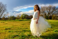 Young girl wearing white dress in late afternoon sun. Royalty Free Stock Photos Young girl wearing white dress in late afternoon sun. Royalty Free Stock Photos