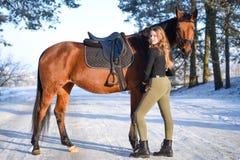 Young Girl With Horse On Winter Forest Road Royalty Free Stock Photography