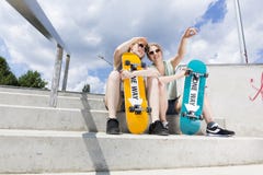 Young girls sitting on the stairs with skateboards stock photos Young girls sitting on the stairs with skateboards stock photos