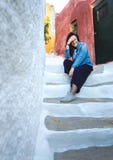 Young Greek girl on the steps of narrow streets in the tourist area of Athens Anafiotika in Greece royalty free stock photos Young Greek girl on the steps of narrow streets in the tourist area of Athens Anafiotika in Greece royalty free stock photos