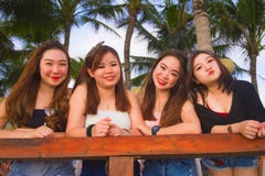 Young group of happy and beautiful Asian Chinese girls having holidays together hanging out enjoying at tropical resort in friends stock photography Young group of happy and beautiful Asian Chinese girls having holidays together hanging out enjoying at tropical resort in friends stock photography