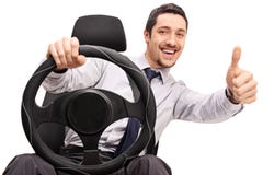 Young guy driving and giving a thumb up stock photo Young guy driving and giving a thumb up stock photo