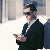 Young handsome business man using smart phone in city street Stock Photo Young handsome business man using smart phone in city street Stock Photo