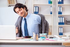The young handsome businessman in budget planning concept stock images The young handsome businessman in budget planning concept stock images