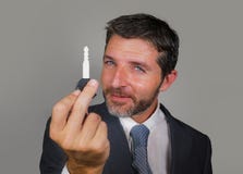 Handsome and confident salesman showing car key offering buying new truck or motorbike smiling cheerful isolated on grey stock photo Handsome and confident salesman showing car key offering buying new truck or motorbike smiling cheerful isolated on grey stock photo
