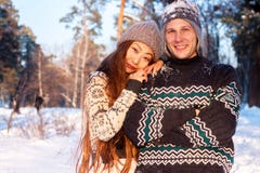 A young handsome man of European appearance and a young Asian girl in a park on the nature in winter royalty free stock images A young handsome man of European appearance and a young Asian girl in a park on the nature in winter royalty free stock images