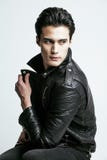 Young handsome man, leather jacked on naked torso, emotional posing, white background, modern guy, lifestyle people Royalty Free Stock Photos Young handsome man, leather jacked on naked torso, emotional posing, white background, modern guy, lifestyle people Royalty Free Stock Photos