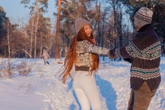 A young handsome man of European appearance and a young Asian girl in a park on the nature in winter royalty free stock photography A young handsome man of European appearance and a young Asian girl in a park on the nature in winter royalty free stock photography