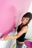 Young Happily Woman Painting Wall Pink DIY Project Stock Image