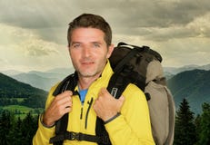 Young happy and attractive hiker man carrying backpack posing cheerful during mountain hike smiling enjoying beautiful nature trip stock image Young happy and attractive hiker man carrying backpack posing cheerful during mountain hike smiling enjoying beautiful nature trip stock image