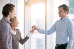 Young happy couple is given a key stock photography Young happy couple is given a key stock photography