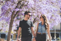 Young happy couple walking together holding hands royalty free stock photo Young happy couple walking together holding hands royalty free stock photo