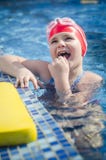Young happy girl learning to swim in the pool with foam board royalty free stock photo Young happy girl learning to swim in the pool with foam board royalty free stock photo