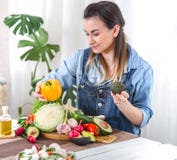 Young and happy woman eating salad at the table stock photos Young and happy woman eating salad at the table stock photos