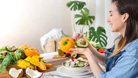 Young and happy woman eating salad at the table royalty free stock images Young and happy woman eating salad at the table royalty free stock images