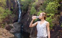 Young healthy woman drinks water from bottle.Outdoor Stock Photos Young healthy woman drinks water from bottle.Outdoor Stock Photos