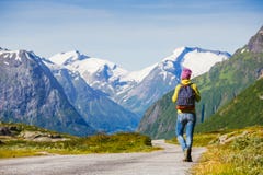 Young hipster female traveler on road stock photo Young hipster female traveler on road stock photo