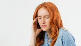 Young hopeless red hair woman suffering from depression having nervous breakdown holding her head on isolated background, copy royalty free stock image Young hopeless red hair woman suffering from depression having nervous breakdown holding her head on isolated background, copy royalty free stock image