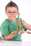 Young kid playing with dinosaurs