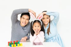 Young lovely Asian family, parents and small kid girl doing funny pose and smiling together at home. Happy family love concept stock image Young lovely Asian family, parents and small kid girl doing funny pose and smiling together at home. Happy family love concept stock image