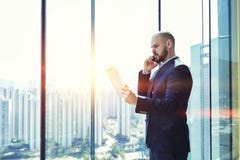 Young male CEO having serious mobile phone conversation Royalty Free Stock Image Young male CEO having serious mobile phone conversation Royalty Free Stock Image