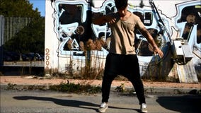 Young male hip-hop dancer dancing outside