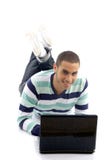 Young male lying on the floor and busy with laptop royalty free stock image Young male lying on the floor and busy with laptop royalty free stock image