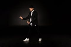 Young male modern dancer in black clothes and hat stock image Young male modern dancer in black clothes and hat stock image