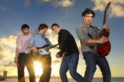 Young male musicians with instruments at sunset royalty free stock photography Young male musicians with instruments at sunset royalty free stock photography