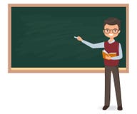 Young male teacher is writing chalk on a school blackboard