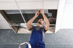 Young male technician repairing air conditioner royalty free stock photos Young male technician repairing air conditioner royalty free stock photos