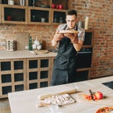 Young man cooking homemade pizza royalty free stock photography Young man cooking homemade pizza royalty free stock photography