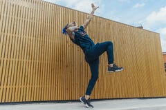 Young man with blue dreadlocks dancing reggaeton in the street. stock photo Young man with blue dreadlocks dancing reggaeton in the street. stock photo