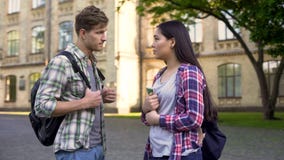 Young man communicates with geek girl student, asks for help in exam preparation royalty free stock photos Young man communicates with geek girl student, asks for help in exam preparation royalty free stock photos