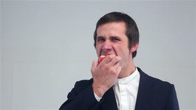 Young man eating an apple stock footage Young man eating an apple stock footage