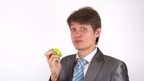 Young man eating an apple stock video Young man eating an apple stock video