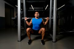 Young man exercising with barbell Squats royalty free stock image Young man exercising with barbell Squats royalty free stock image