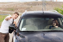 Young Man Giving Directions To A Woman Driver Stock Photography