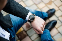 Young man in gray jacket and jeans, elegant business man`s hand Royalty Free Stock Images Young man in gray jacket and jeans, elegant business man`s hand Royalty Free Stock Images