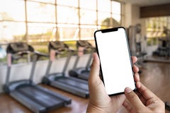 Young man Hand holding smartphone in gym to fitness phone fitne stock photo Young man Hand holding smartphone in gym to fitness phone fitne stock photo