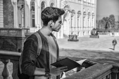 Young Man Holding a Guide Outside Historic Building Stock Images Young Man Holding a Guide Outside Historic Building Stock Images