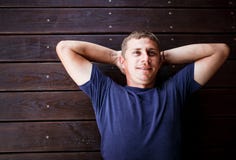 Young man lying and relaxing on wooden deck outdoor. stock photos Young man lying and relaxing on wooden deck outdoor. stock photos