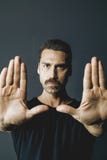 Young man with moustache framing his face with his hands Stock Photography Young man with moustache framing his face with his hands Stock Photography
