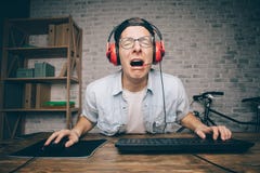 Young man playing game at home and streaming playthrough or walkthrough video royalty free stock images Young man playing game at home and streaming playthrough or walkthrough video royalty free stock images
