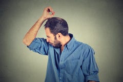 Young man, smelling, sniffing his armpit, something stinks royalty free stock photos Young man, smelling, sniffing his armpit, something stinks royalty free stock photos