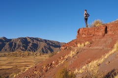 Young man watching over dry and empty landscape in Bolivia stock photo Young man watching over dry and empty landscape in Bolivia stock photo