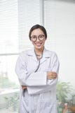 Young medical doctor woman standing on hospital background royalty free stock images Young medical doctor woman standing on hospital background royalty free stock images